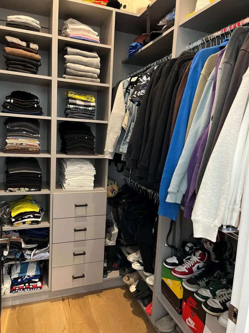 The same walk-in after, floor cleared, shoes lined up on the shelf and the hanging sorted