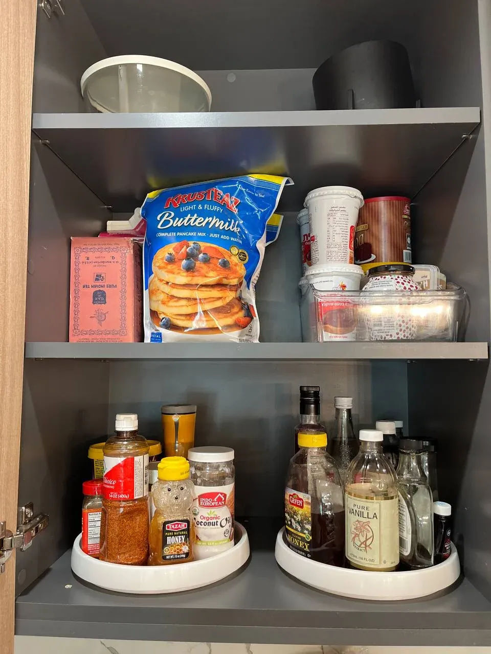 Baking cabinet with pancake and buttermilk mix above and two turntables holding syrups and oils below
